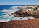 Dramatic coastline of Lanzarote with white traditional houses.jpg