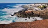 Dramatic coastline of Lanzarote with white traditional houses.jpg