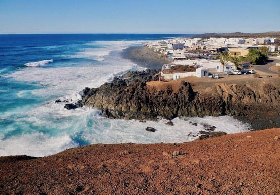 Dramatic coastline of Lanzarote with white traditional houses.jpg