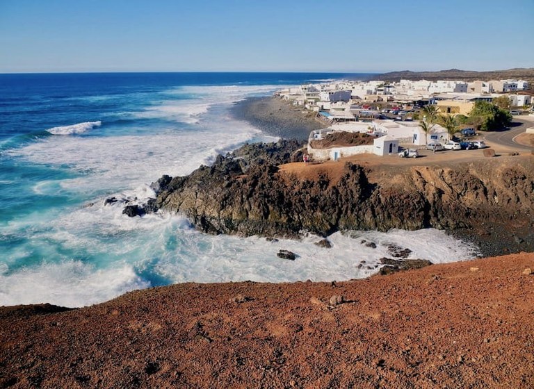 Dramatic coastline of Lanzarote with white traditional houses.jpg