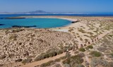 Cycling in Lobos island with white sand beach and turquoise waters.jpg