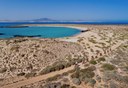 Cycling in Lobos island with white sand beach and turquoise waters.jpg