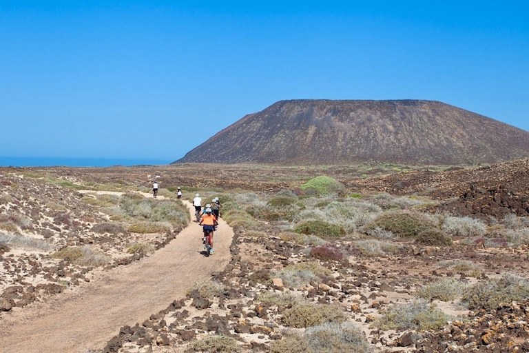 Riding E-bike in Lobos island with volcano cone.jpg