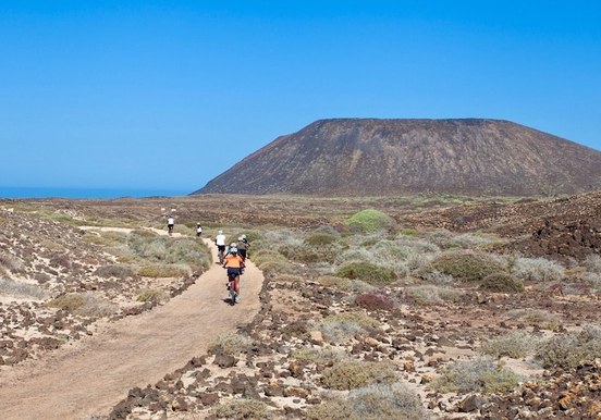 Riding E-bike in Lobos island with volcano cone.jpg