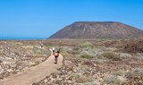 Riding E-bike in Lobos island with volcano cone.jpg