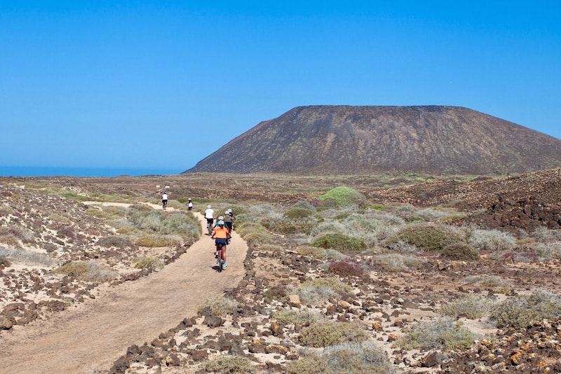 Riding E-bike in Lobos island with volcano cone.jpg