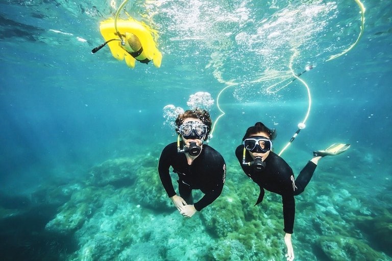Couple enjoying underwater scuba snorkel in Lobos island.jpg