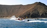Private boat sailing around Lobos Island - La Caldera Mountains