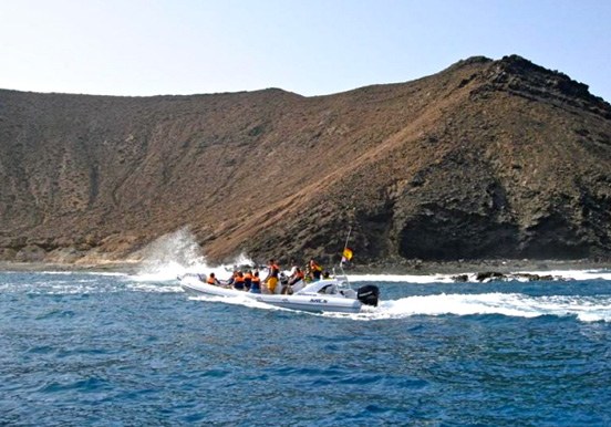 Private boat sailing around Lobos Island - La Caldera Mountains