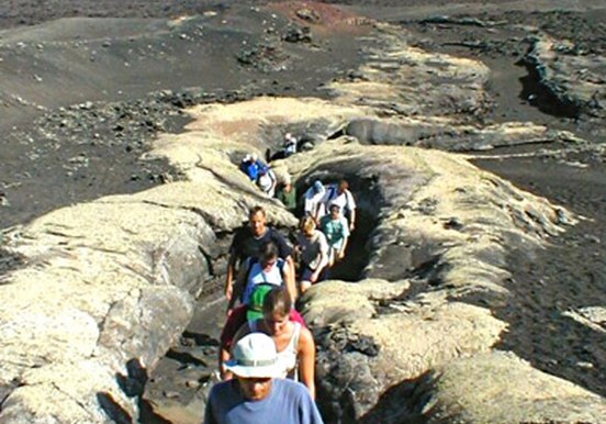 hiking through volcanic rock formation in Lanzarote