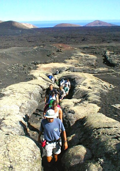 hiking through volcanic rock formation in Lanzarote