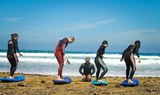 surfing course students with instructor in lanzarote coast