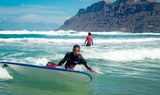 learning to surf in the waves in Lanzarote